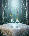 Enchanted Bellflower Earrings displayed on marble Celtic pedestal in misty forest